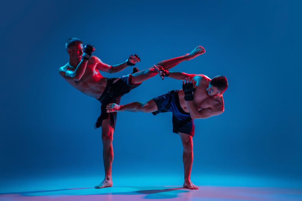mma two professional fighters punching boxing isolated blue wall neon
