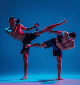 mma two professional fighters punching boxing isolated blue wall neon